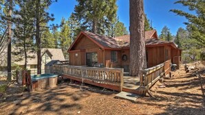 A cabin with a deck, surrounded by trees. - Sunrise Pines Cabin | Spa · Near Village (Big Bear Lake)