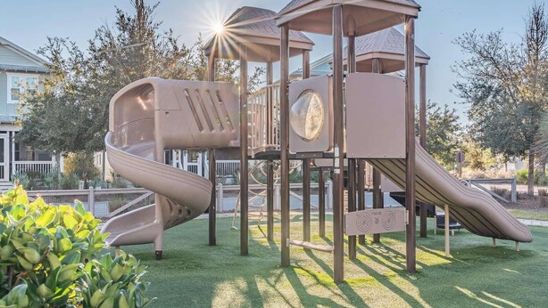 A playground with a slide, climbing area, and a covered playhouse. - 3,000+ Sq Ft! Golf Cart & 6 Bikes! Walk to 2 Pools! 3 King Suites and Bunk Room! ~ Unwined at Naturewalk on 30A (Santa Rosa Beach)