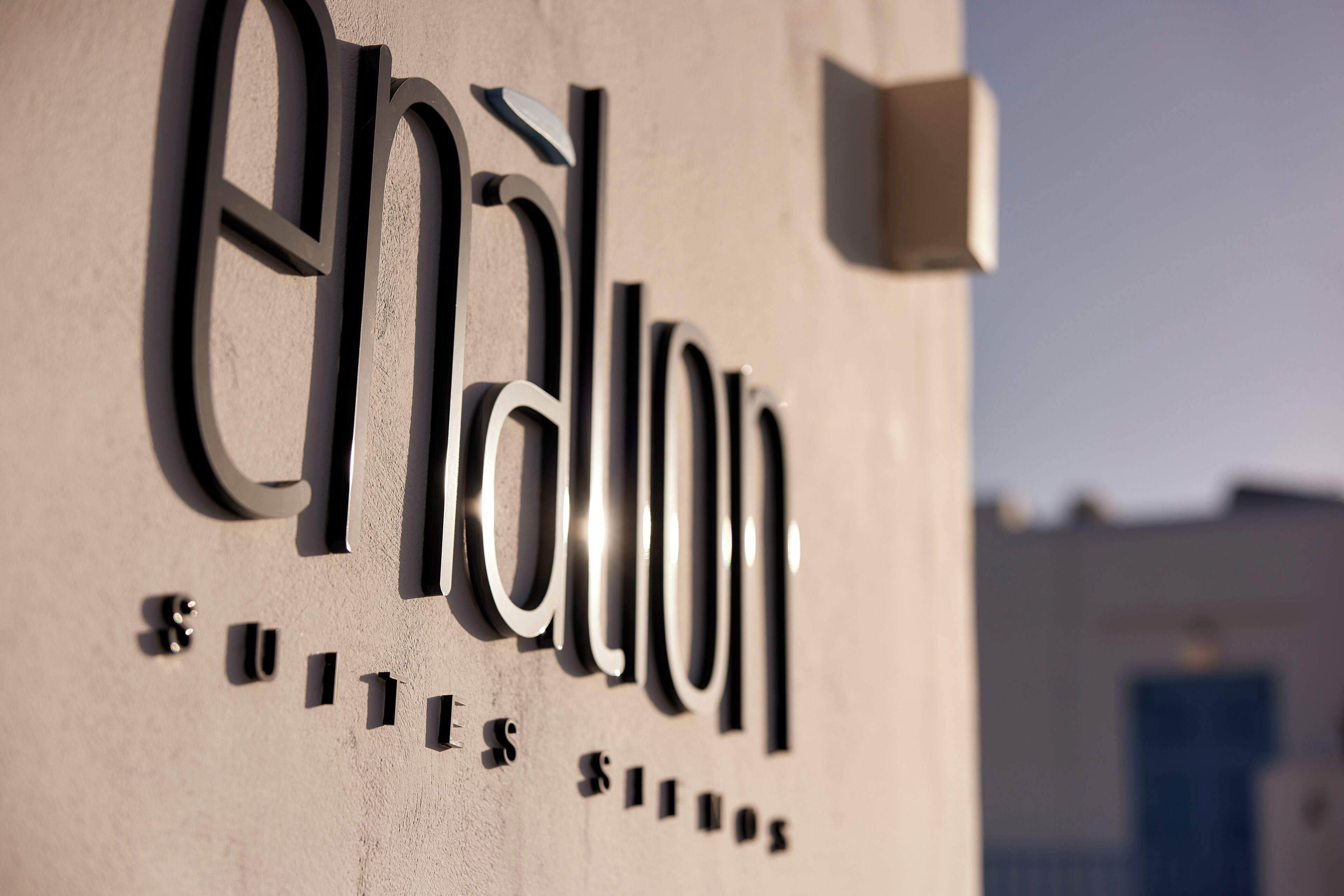 A building sign with the name 'Enchalon' and the words 'SUITES SUILES' below it.