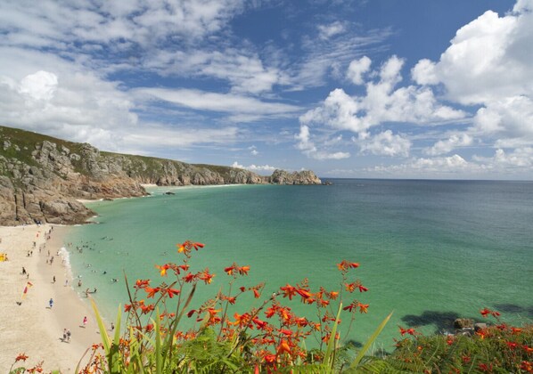 Guests can enjoy the beach with turquoise waters and a sandy shoreline.