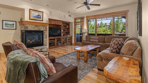 A spacious living room with a fireplace, a large TV, and comfortable seating. - Multiple Hot Tubs | Walk to Slopes | Free Winter Shuttle (Steamboat Springs)
