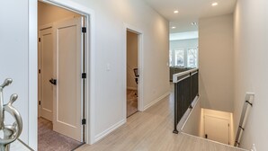 A modern interior with a hallway leading to a staircase. - 7 Mi to Downtown: Luxe Chicago Condo (Chicago)