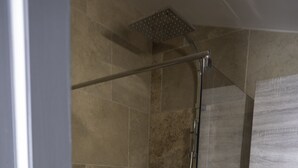 A shower with a glass door, a metal showerhead, and a tiled wall. - AU Coeur DU Luberon Idealement Situe Pour Visiter LE Region (Gargas)