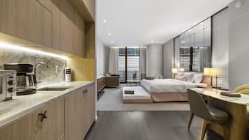 Luxury Studio Suite, 1 King Bed with Sofa bed, City View | Private kitchen | Fridge, coffee/tea maker, cleaning supplies, paper towels
