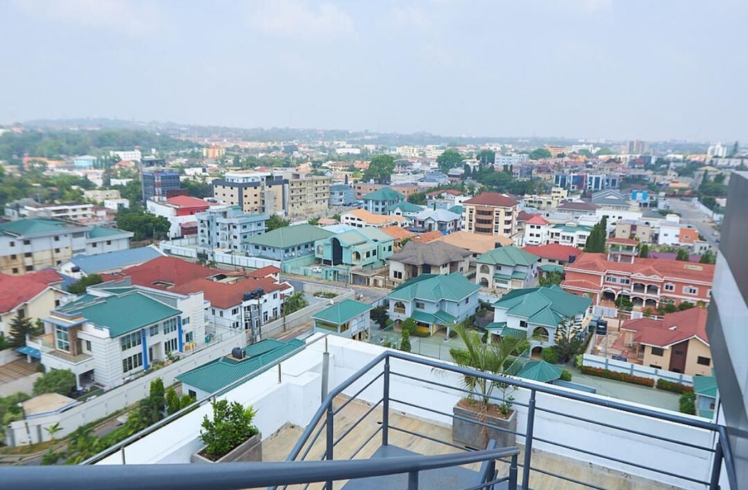 A residential area with various buildings, including houses and apartment complexes, with a clear view of the surrounding neighborhood.