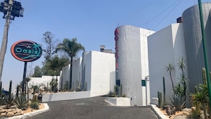 A modern building with a sign for Oasis Auto Hotel.