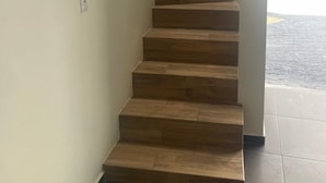 A staircase with wooden steps leading to a landing.