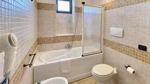 Une salle de bain avec une baignoire, des toilettes et un lavabo.