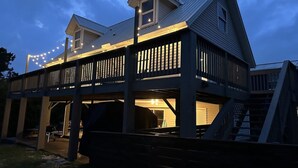 A two-story building with a balcony and a covered area. - 3bd 2ba Sleeps 10 Golf Cart Included Pet Friendly (Panama City Beach)