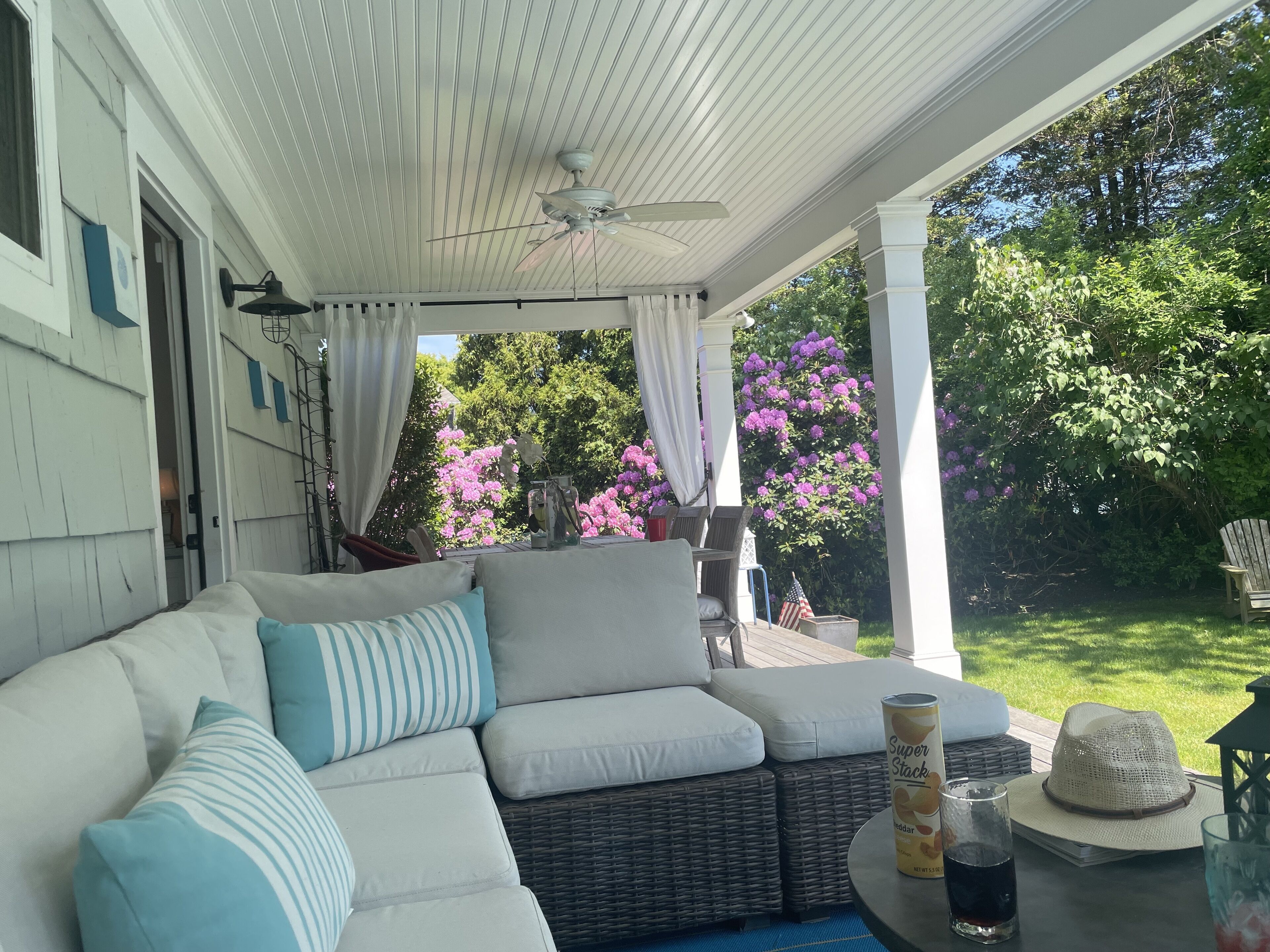Couches on covered porch and outdoor dining table for 8 