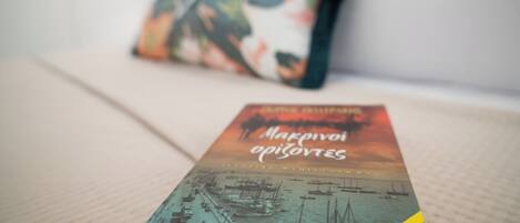 A book titled "Marseille" on a bed with a pillow in the background.