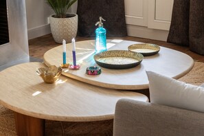 Relax in a stylish living area with a comfortable sofa, coffee table, and potted plant.