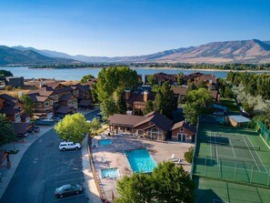 A residential area with houses, a swimming pool, and a tennis court. - Lakeside Funscape LS33 | Ski & Snowboard | Hot Tub (Huntsville)