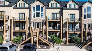 A row of townhouses with balconies, wooden staircases, and a clear driveway. - Eden Mtn Retreat MH207 | Near Powder Mtn | Hot Tub (Eden)