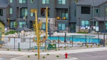 The community pool and hot tub are enclosed in a fence for safety.
