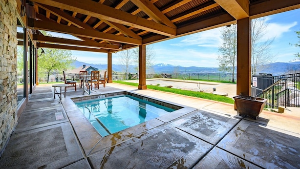 A covered outdoor pool area with a view of mountains. - Powder Mtn Wolf Den TR11|Mtn Biking |Dog Friendly (Eden)