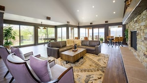 A spacious living area with a large sectional sofa, a coffee table, and a dining table set for four. - Powder Mtn Wolf Den TR11|Mtn Biking |Dog Friendly (Eden)