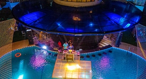 A pool area with a DJ booth and a glass ceiling. - The Nook Apartments (Port Harcourt)