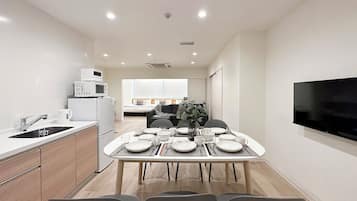 Premium Apartment | Living area | 43-inch Smart TV with cable channels