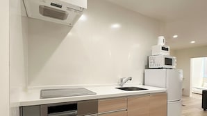 A modern kitchen with a built-in dishwasher, a sink, and a refrigerator. - Nikke 201 (Hiroshima)