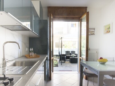 Elegant and spacious apartment with private garden and garage near the sea.