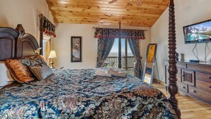 A four-poster bed with a canopy, a wooden ceiling, a television on a dresser, and a balcony with curtains. - Lovely Cabin on Appalachian Ski Mountain (Blowing Rock)