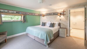 A bedroom with a bed, bedside table, and a window.