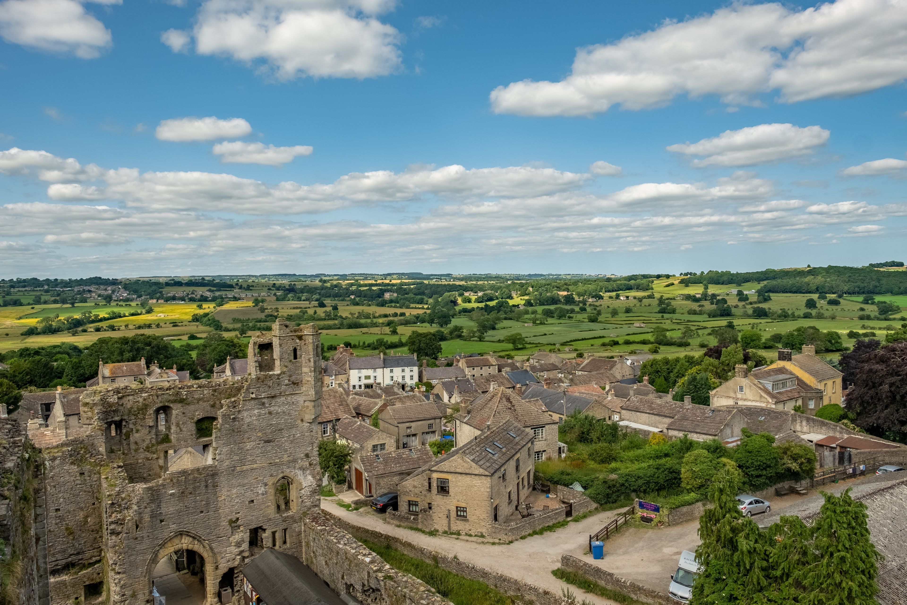 A historic town with medieval architecture, including a castle and stone buildings.