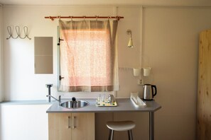 Family Cabin, Garden View | Private kitchen | Full-size fridge, microwave, stovetop, cookware/dishes/utensils