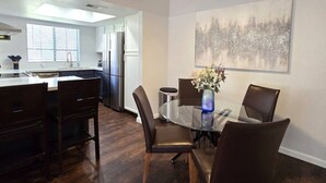 A modern kitchen with a dining area, a ceiling fan, and a large window. - Tempe 2Bdrm 2Ba by Papago Park A101 (Tempe)