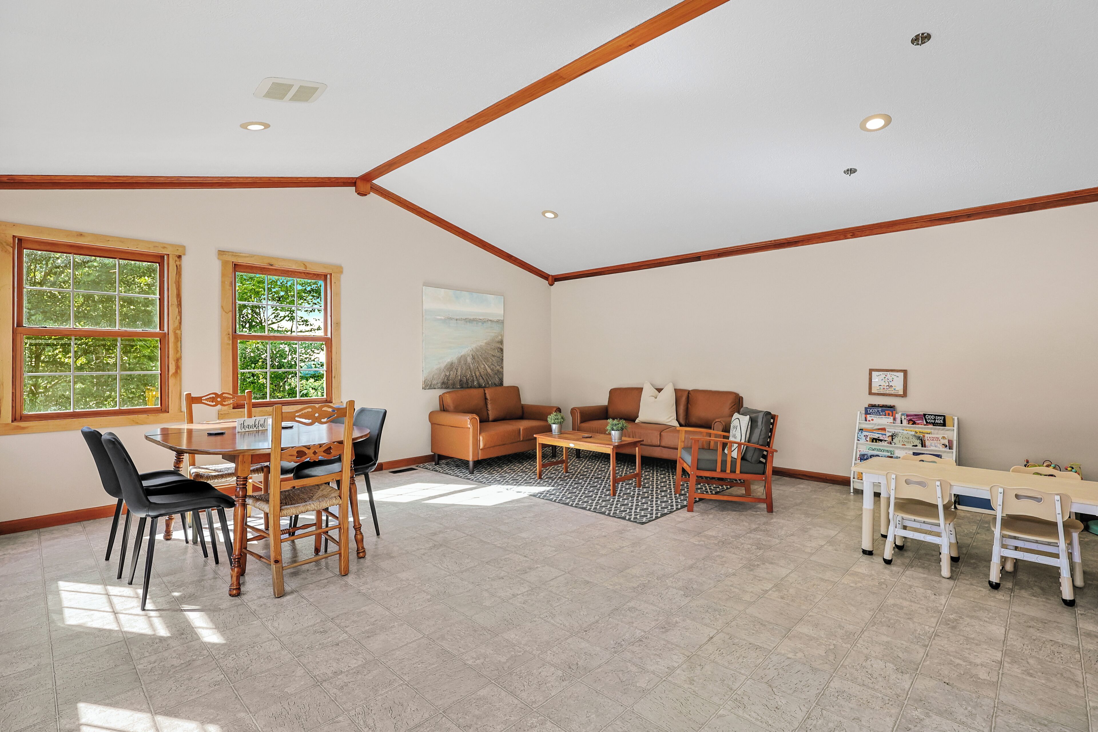 Additional gathering space with seating, dining area, and a dedicated kids' corner.