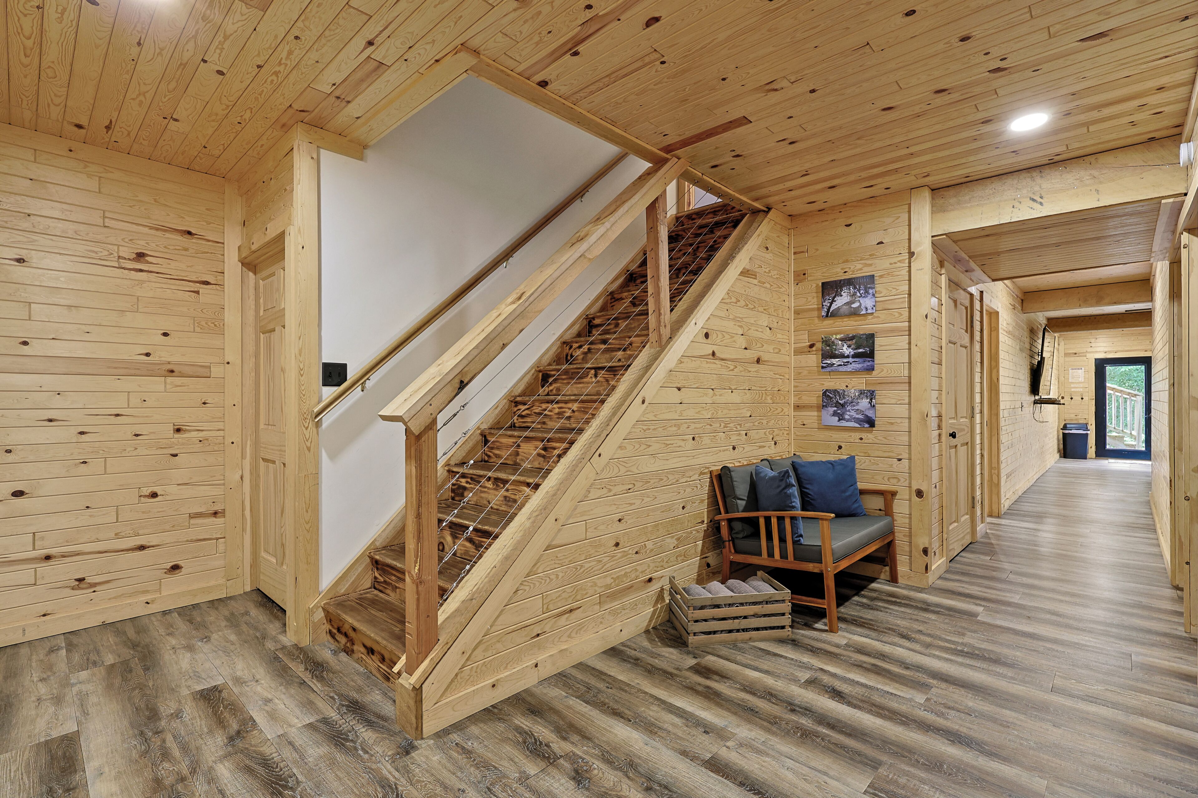 Finished lower level featuring two bunk rooms that sleep up to 12 guests, a full bathroom, theater room, and walks outside to a 6-person hot tub. 
