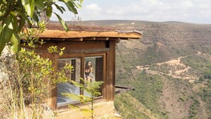 A rustic wooden cabin with a large window, overlooking a mountainous landscape. - Refugio La Roca  (Los Santos)
