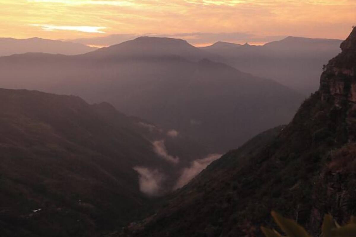 A mountainous landscape with a valley and a river.