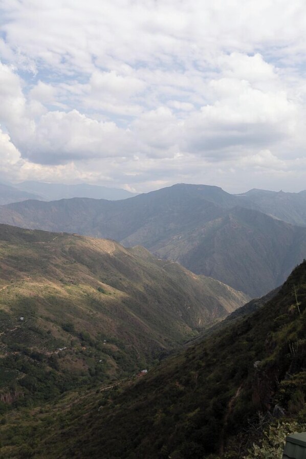 A mountainous landscape with terraced fields and a clear sky.