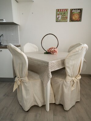 Enjoy meals in this cozy dining area with a table, chairs, and decorative mirror.