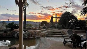 A patio area with a pool, outdoor seating, and a sunset view. - Santa Clarita Tropical Paradise, Six Flags Magic Mountain, LA, Beaches Drivable (Santa Clarita)