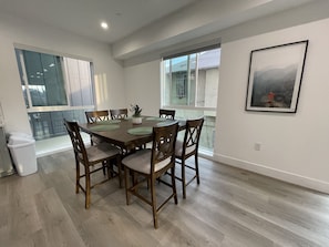 Enjoy meals in this cozy dining area with a wooden table and six comfortable chairs.