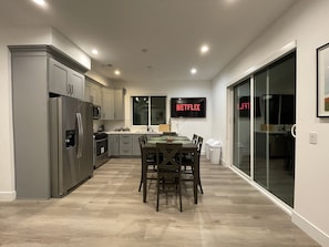 Enjoy cooking and dining in this well-equipped kitchen with a central island, dining area, and TV.