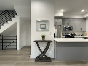 Enjoy cooking in this well-equipped kitchen with a central island, stainless steel appliances, and ample counter space.