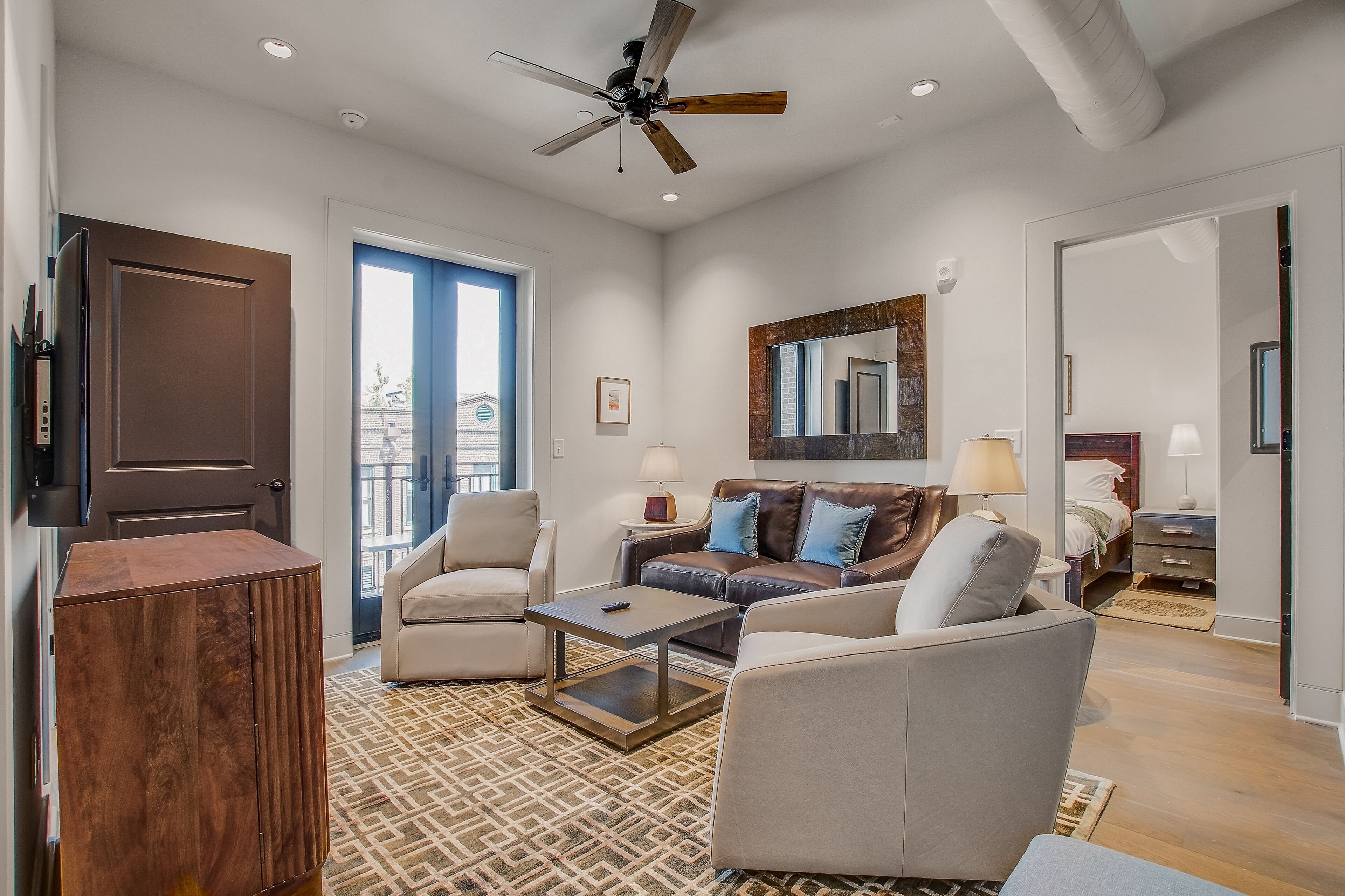 Sleek, peaceful condo with a full kitchen, balcony, & rooftop deck