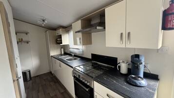 Fridge, coffee/tea maker, electric kettle, cookware/dishes/utensils