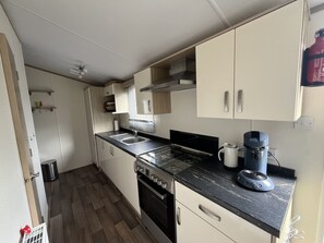 Fridge, coffee/tea maker, electric kettle, cookware/dishes/utensils