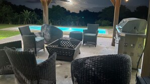 An outdoor patio with wicker furniture, a barbecue grill, and a pool. - Hidden Paradise w/ Pool (Guaynabo)