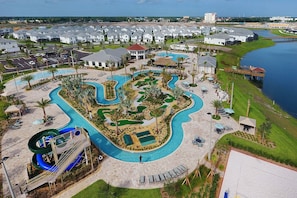 A resort with a large swimming pool, a water slide, and a golf course. - Lovely Family Home - 10min to Disney - Stl107 (Kissimmee)