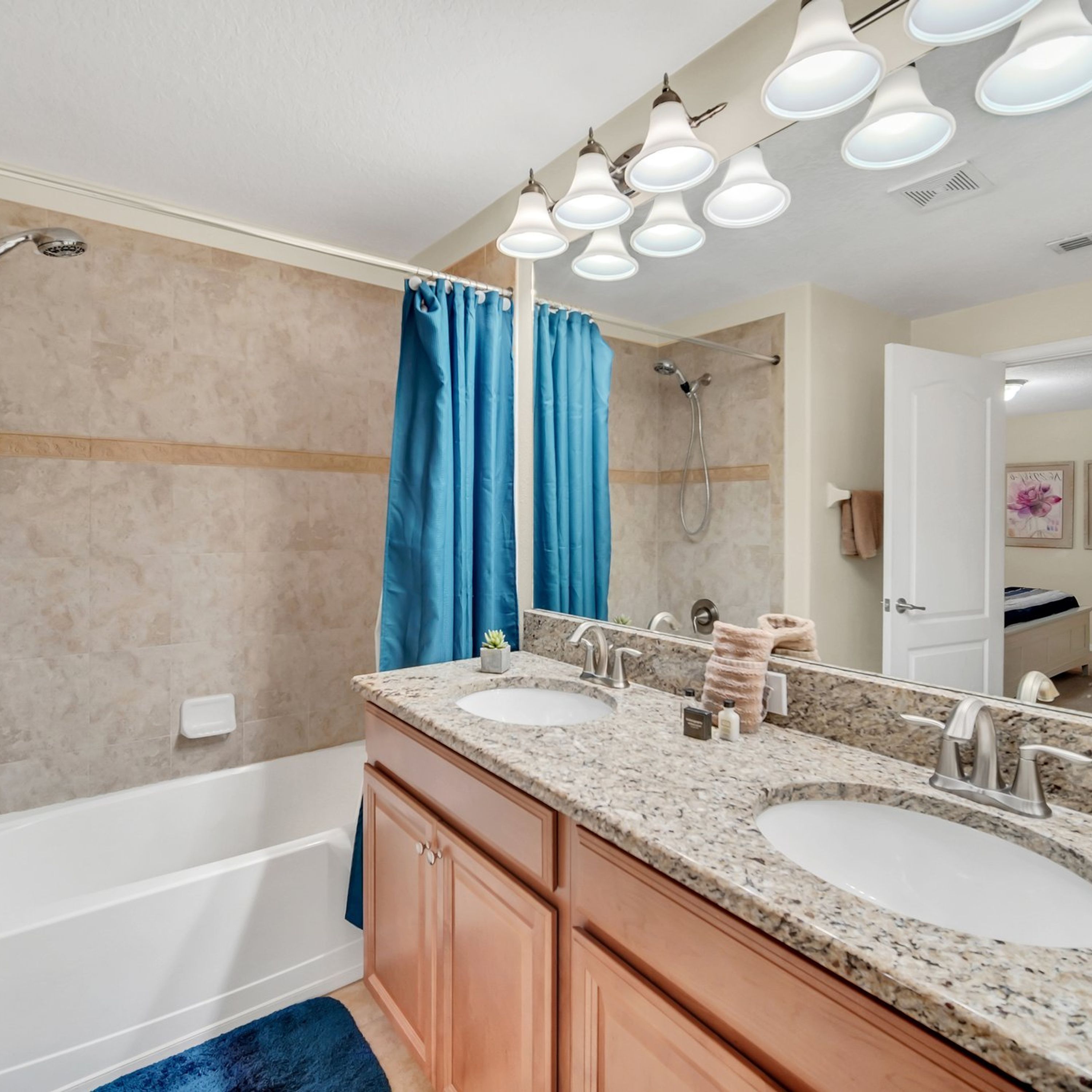 A bathroom with two sinks, a shower, and a bathtub.