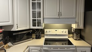 A kitchen with white cabinets, a microwave, a stove, and a toaster. - Retreat to my Beautiful Contemporary Home in the Mountain State (Morgantown)