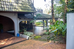A courtyard with a tiled roof, potted plants, and a seating area. - Bangsar Private Pool Villa Kuala Lumpur (Kuala Lumpur)