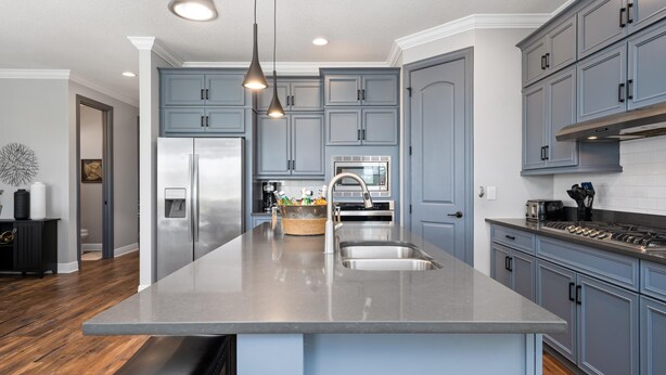 A modern kitchen with a large island, stainless steel appliances, and blue cabinetry. - Entire Home in Four Corners Florida Reu101 (Kissimmee)