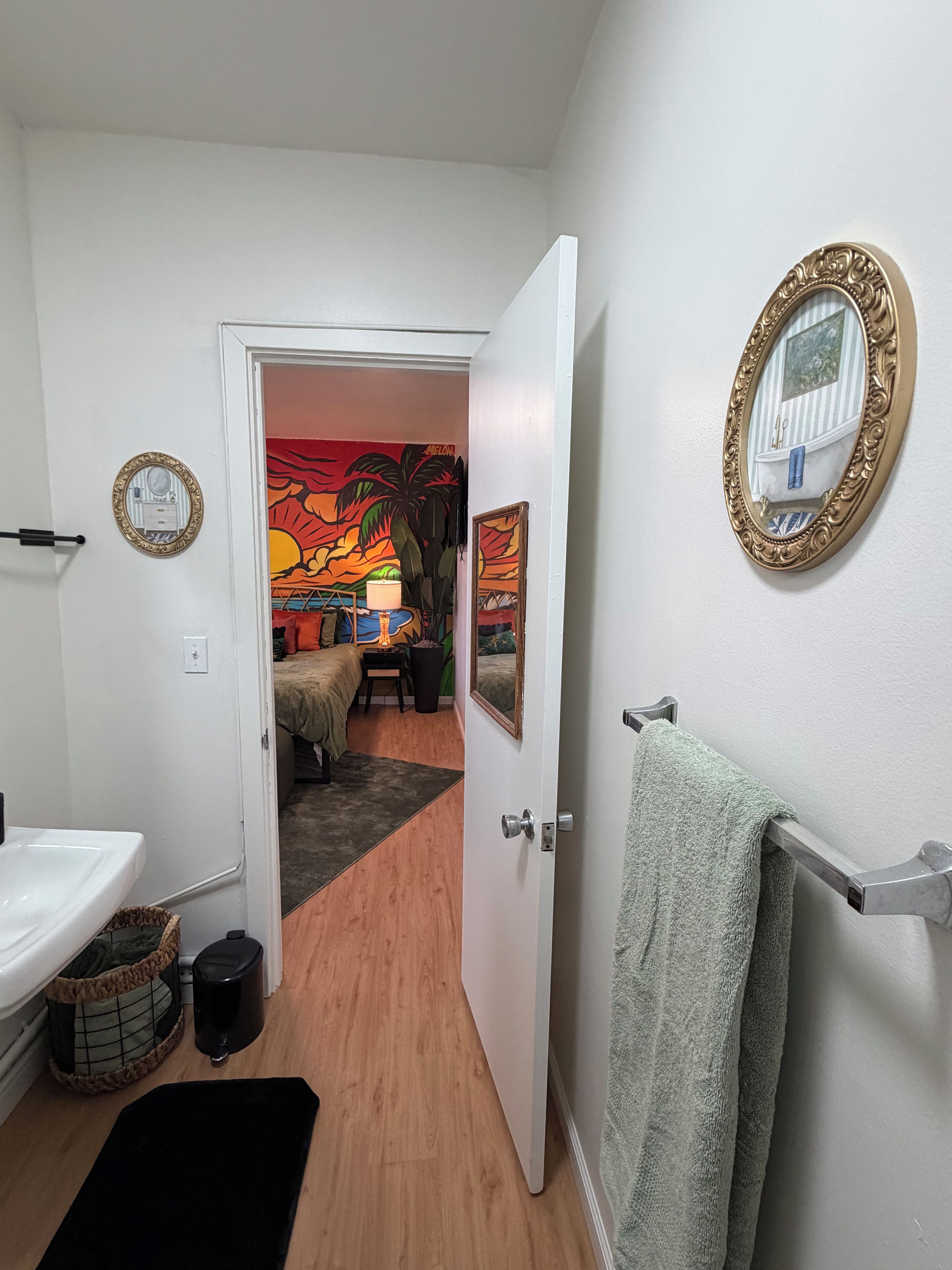 A bathroom with a sink, toilet, and a towel rack.